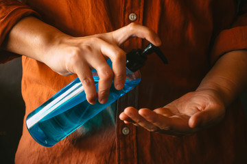 Man washing hands with alcohol gel or antibacterial soap sanitizer. Hygiene concept. Avoid...