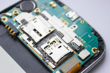 Phone repair. Electronic Board inside the phone. Close, white background.