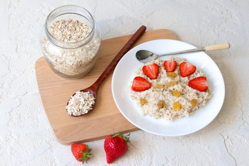 Oatmeal with strawberries for breakfast, carbohydrate healthy breakfast