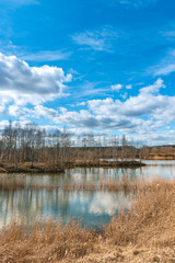 beautiful cloudy sky over a small forest lake in the immediate vicinity of St. Petersburg, Russia