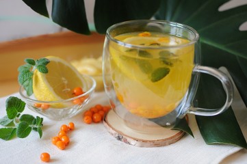 Healthy tea during disease with vitamins - buckthorn tea with lemon and honey.