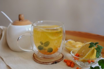 Recovery tea against disease with vitamins - buckthorn tea with lemon and honey.