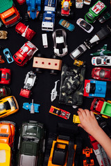 lots of children's toy cars for playing boy on a black