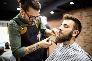 Client during beard and moustache grooming in barber shop