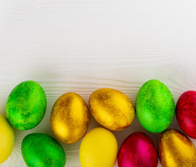 Colorful easter eggs on white wooden textured background, free space for text