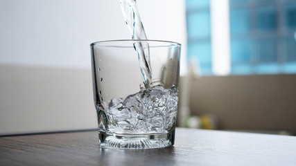 water to drink poured into a glass