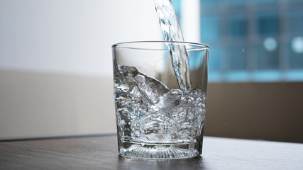 water to drink poured into a glass