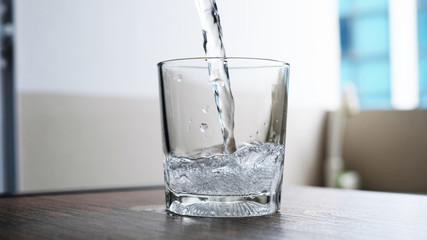 water to drink poured into a glass