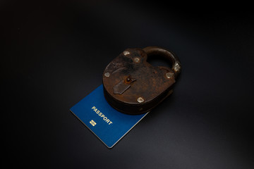 Travel passport locked to padlock. Coronavirus and travel concept. Closing borders between...