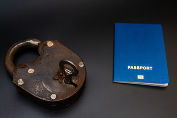 Blue passport with vintage lock and key. Coronavirus, safety and travel concept. Closing borders...