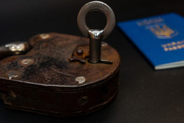 Blue passport with vintage lock and key. Coronavirus, safety and travel concept. Closing borders between countries due to virus