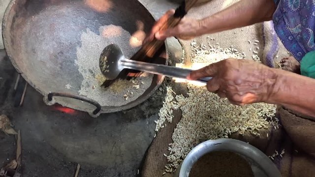 Making puffed rice in the traditional clay stove