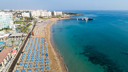 Aerial bird's eye view of Sunrise beach Fig tree, Protaras, Paralimni, Famagusta, Cyprus.The famous tourist attraction family bay with golden sand, boats, sunbeds, restaurants, water sports from above