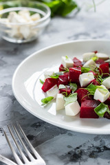 Baked beets with feta cheese and shoots of young peas