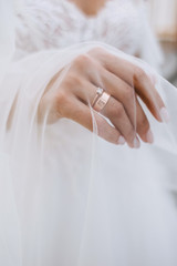 Hand of the bride under the veil. Wedding ring on a girl's hand. The morning of the bride. Wedding Day Preparation