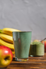 promotional shooting of a fruit cocktail for a healthy eating establishment. In the photo, a glass with a green drink made from fruits and algae spirulina powder