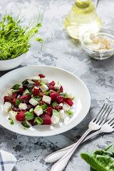 Baked beets with feta cheese and shoots of young peas