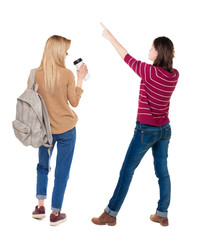 Back view of two pointing girl in sweater.