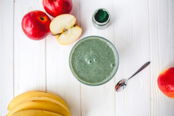 promotional shooting of a fruit cocktail for a healthy eating establishment. In the photo, a glass with a green drink made from fruits and algae spirulina powder
