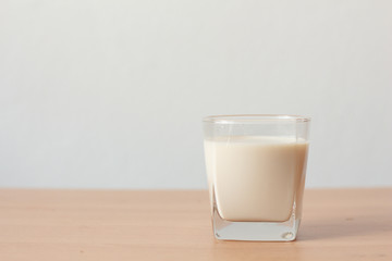 glass of milk on wooden table