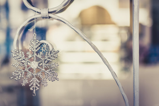 Close-up Of Snowflake Decoration Hanging On Metal During Christmas