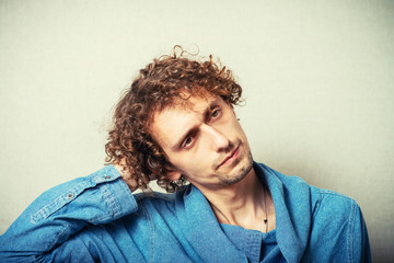 Man holding his hands behind his head