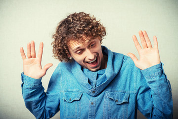 Afraid man in defense attitude gesturing stop with hands