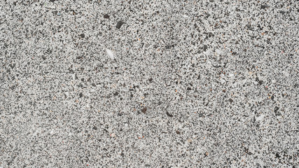 White sand with black stones top view. Natural background