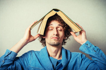 man with a book on his head