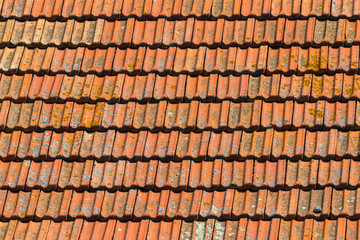 Texture of orange clay roof tiles. Red old dirty roof. Old roof tiles. Construction equipment build...