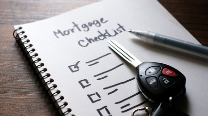 Car keys with mortgage checklist, business concept.