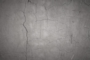 Gray cement concrete wall with cracked plaster. Abstract trendy modern texture background with copy space.