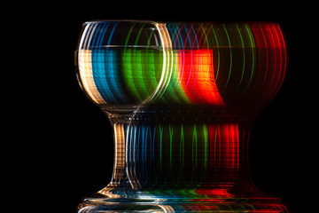moving glass changing color on a black background, blur and strobe