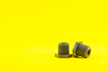 Plastic nut on yellow background.