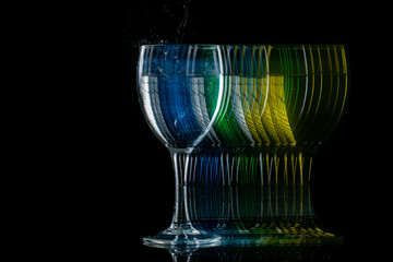 moving glass changing color on a black background, blur and strobe