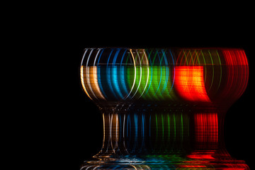 moving glass changing color on a black background, blur and strobe