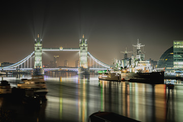 The Tower bridge illuminated at night seen from London bridge