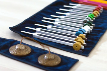 Set of tuning forks and tibetan bells for acoustic healing session