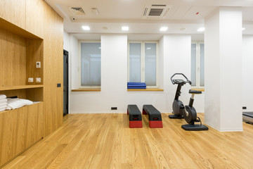 Interior of a small hotel gym with equipment