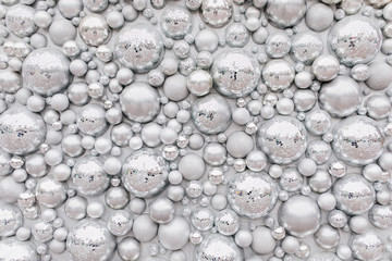 Photo of wall with sparkle elements. Shot of big and little disco balls.
