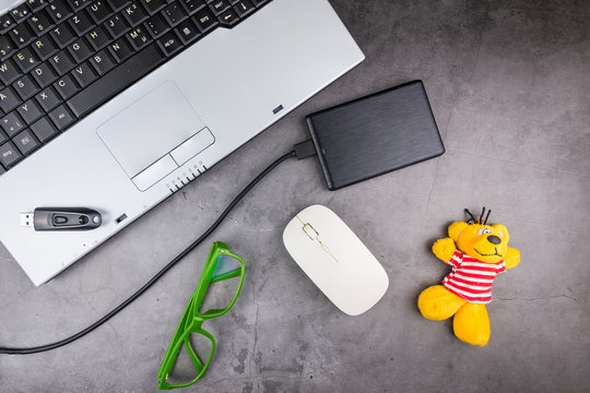 Bangkok, Thailand - April, 04, 2020 : Notebook and Eternal Harddisk on the table, stone pattern.