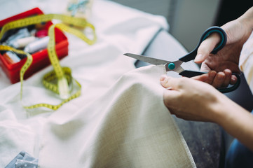 girl master scissors cuts the fabric. handmade. tailor