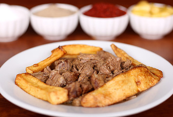 very nice roasting meat potatoes turkish spicy on a white plate close up