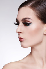 Portrait of young beautiful woman with fancy winged eye make-up, copy space