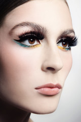 Close-up portrait of young beautiful woman with fancy winged eye make-up