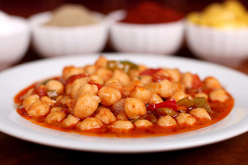 perfect turkish food chickpeas spicy on white plate close up on wooden table