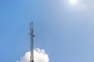 Cell phone, TV, Internet tower rise against a blue sky