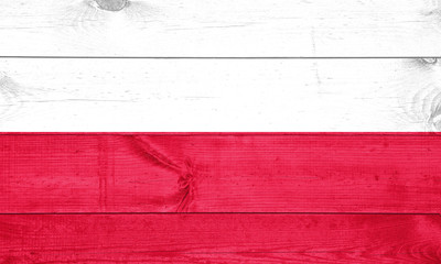 Poland flag depicted in bright paint colors on old wooden wall. Textured banner on rough background