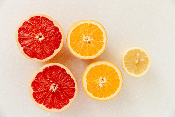 Half of grapefruit, orange, lemon cut for fresh juice. Color splash. Tropical fruits