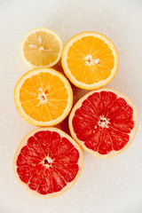 Half of grapefruit, orange, lemon cut for fresh juice. Color splash. Tropical fruits